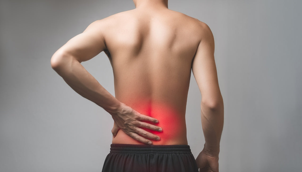 man touching his lower back in pain