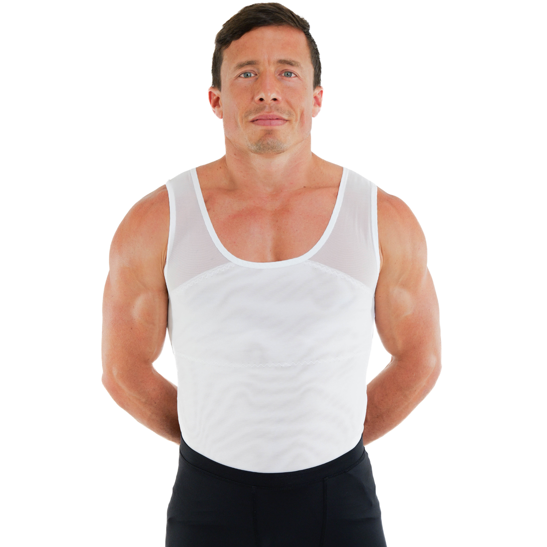 Man wearing a white compression tank top with a smooth chest fit, compression undershirt for men.
